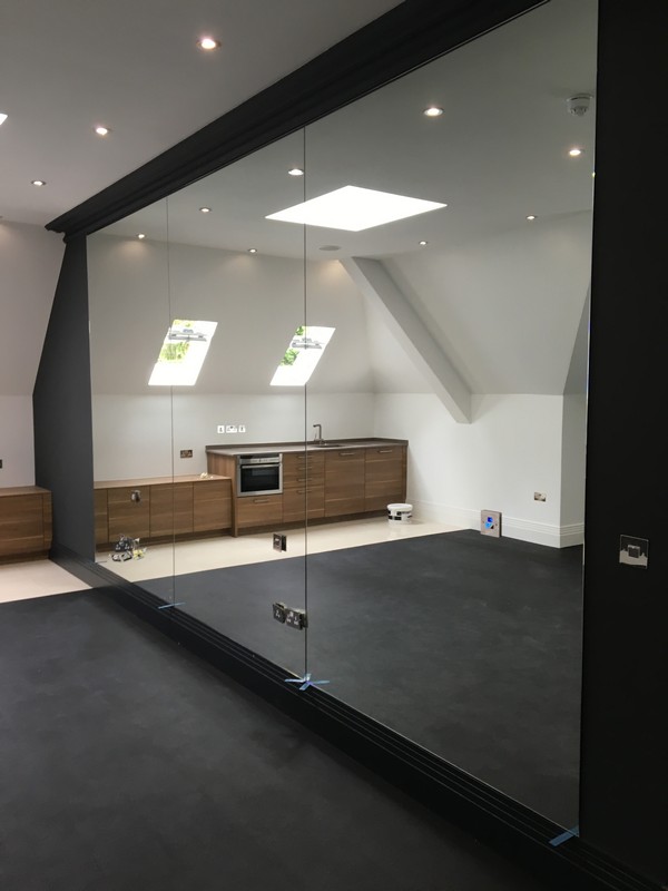 Frameless glass partition in loft conversion by Dulwich glaziers