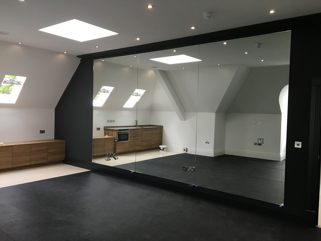 Frameless glass wall dividing loft conversion in Dulwich